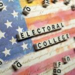 electoral-college-lettered-dice-against-us-flag-istock-1065320490